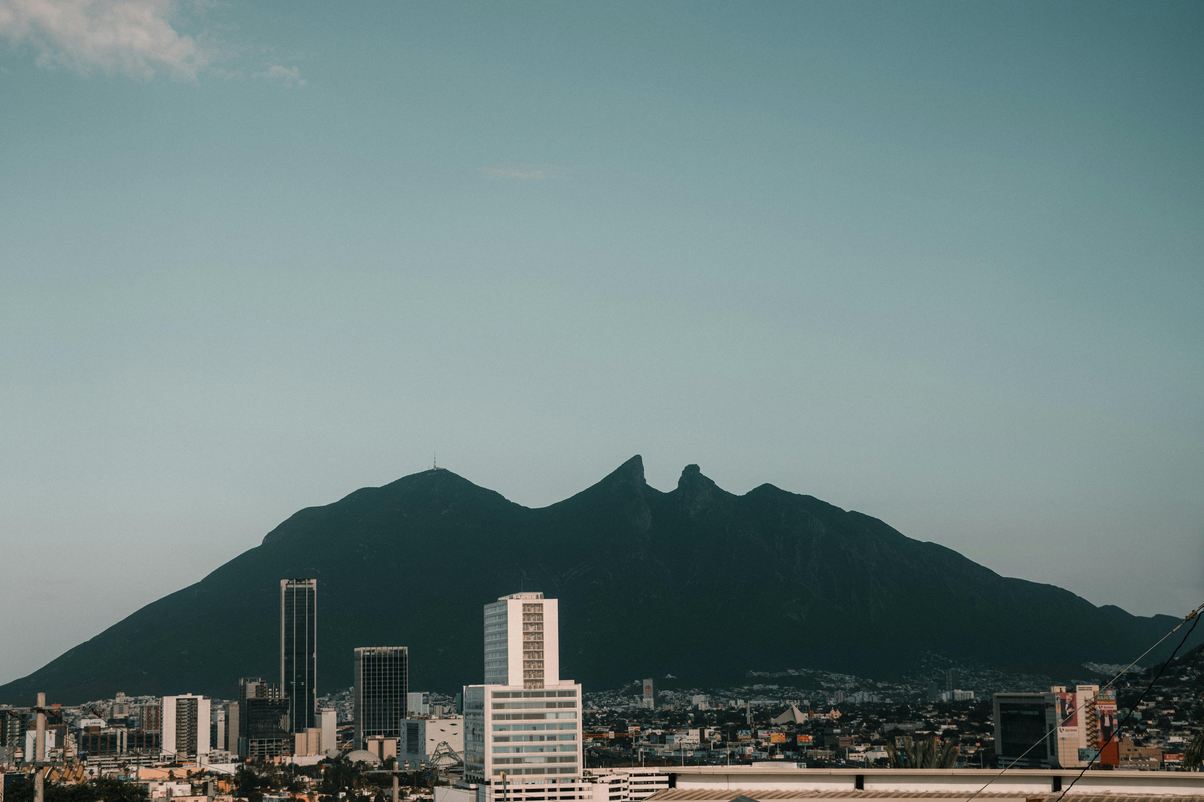 A stunning view of Monterrey cityscape with the iconic Cerro de la Silla mountain in the background.