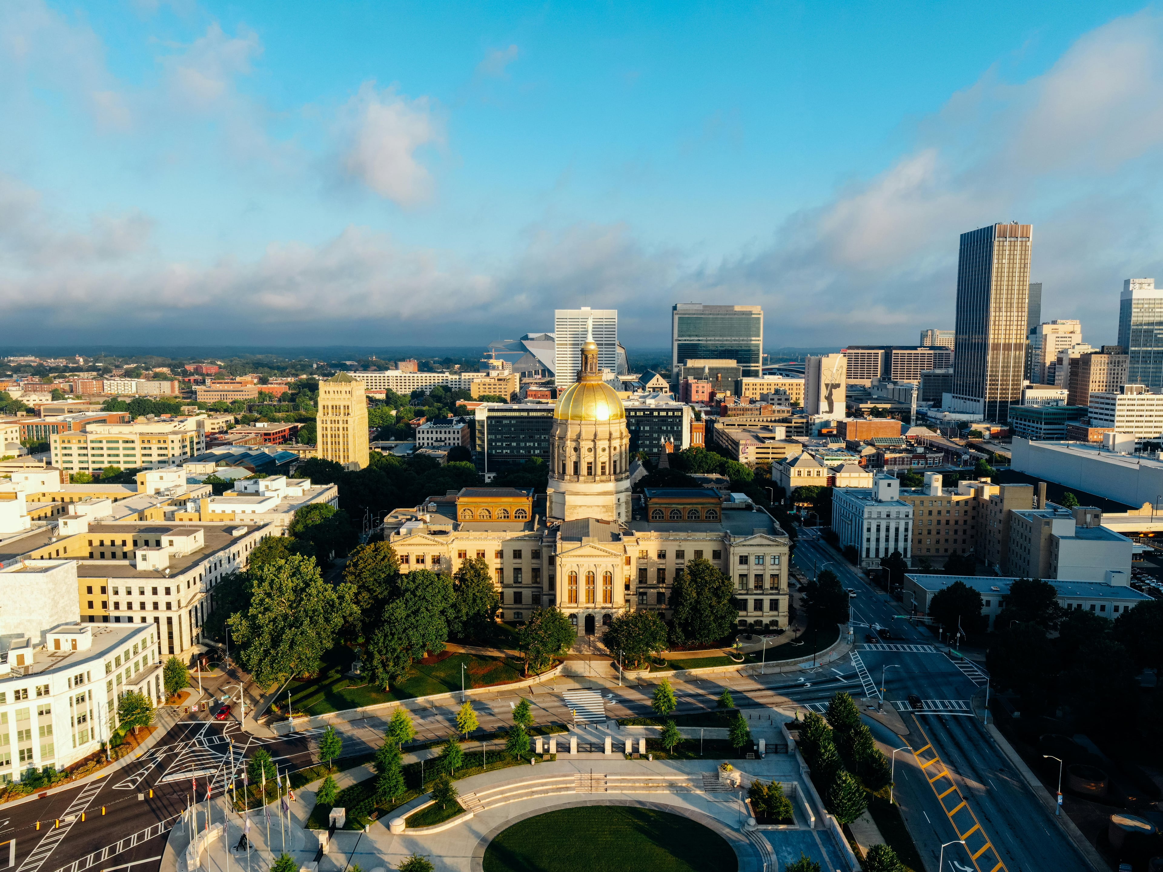 Stunning aerial view of the Georgia State Capitol in downtown Atlanta under a clear blue sky.