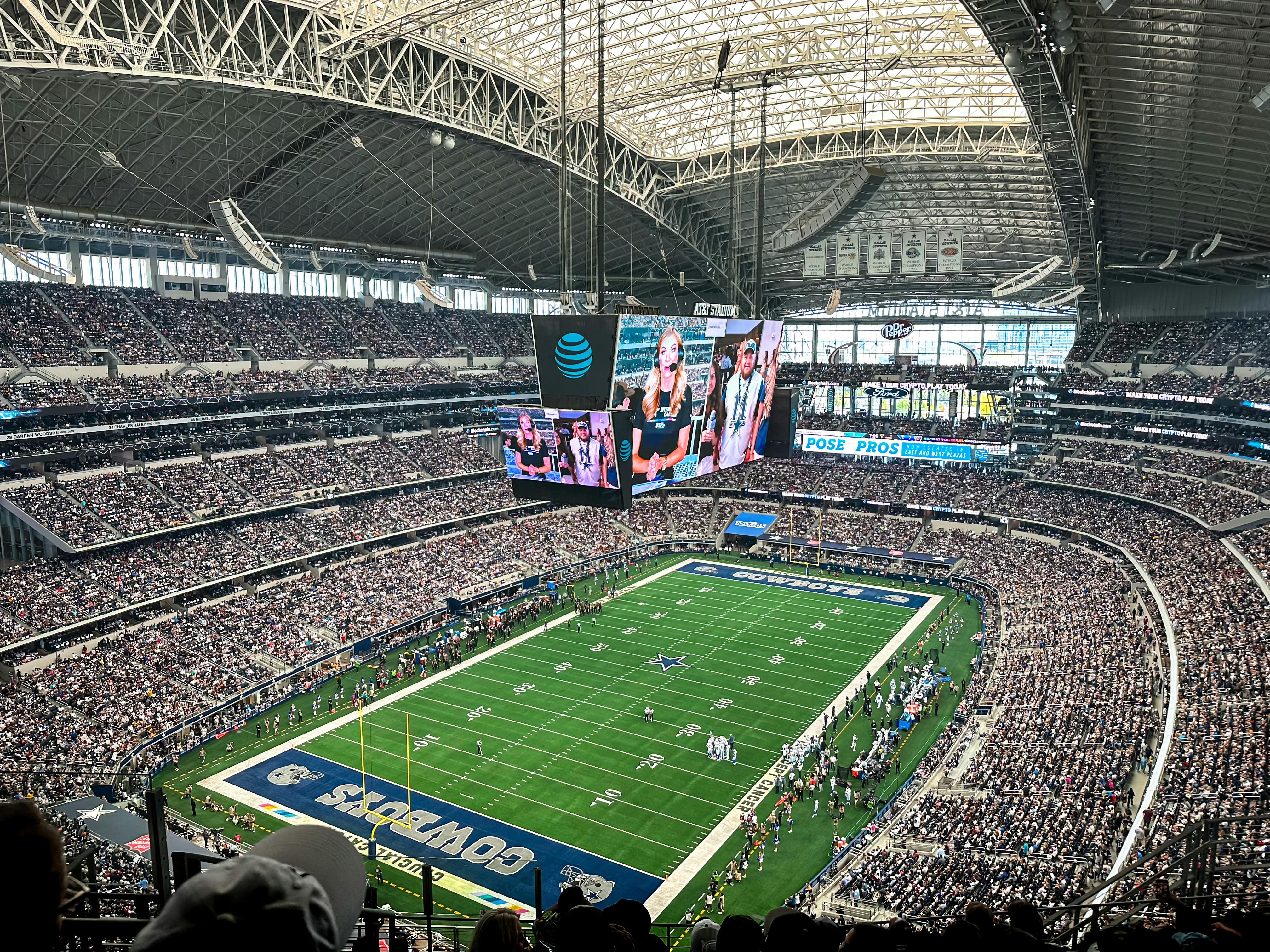 A packed AT&T Stadium in Arlington, Texas, showcasing a thrilling football game with enthusiastic fans.