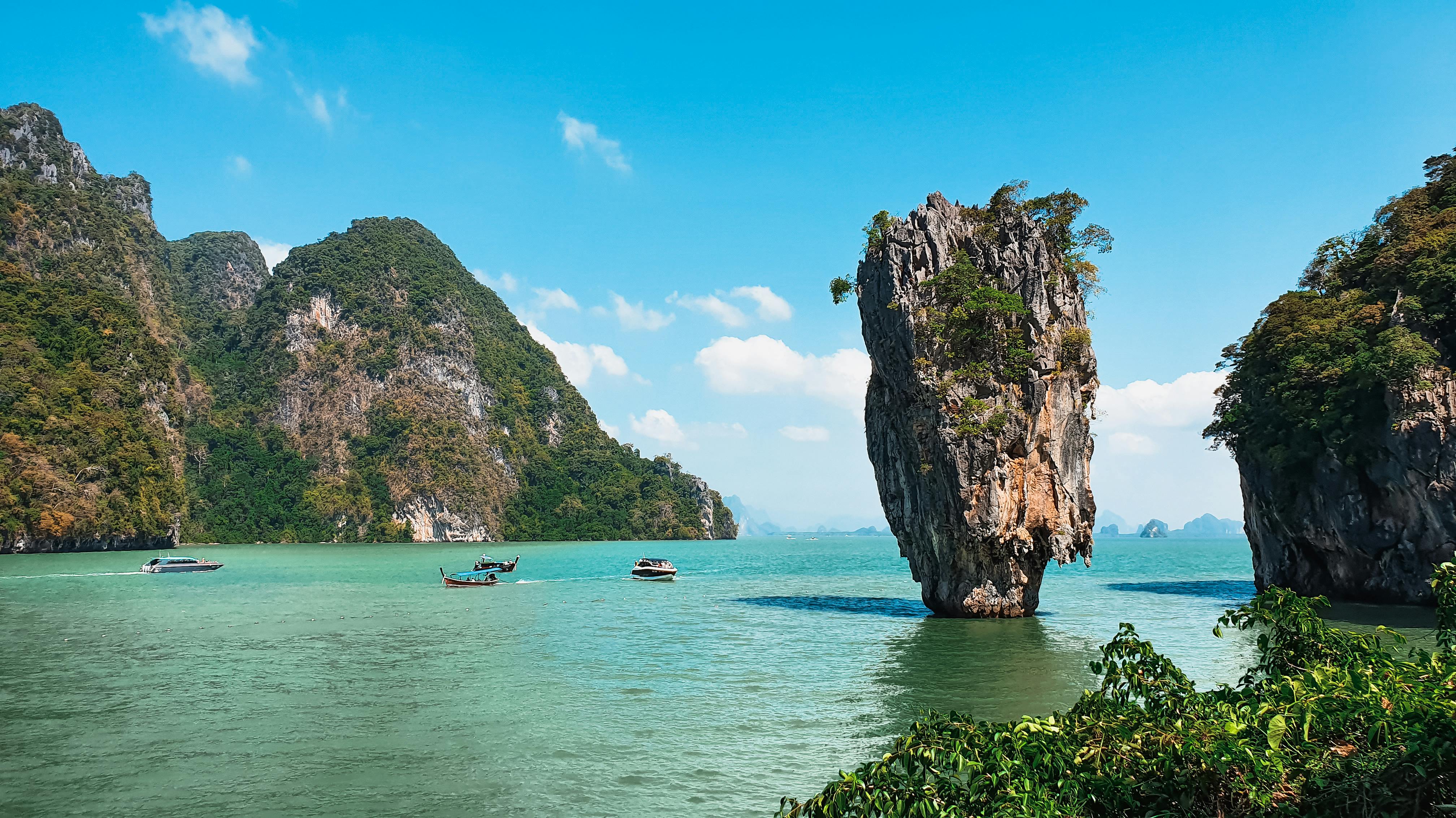 Scenic view of James Bond Island in Thailand with boats and turquoise water.