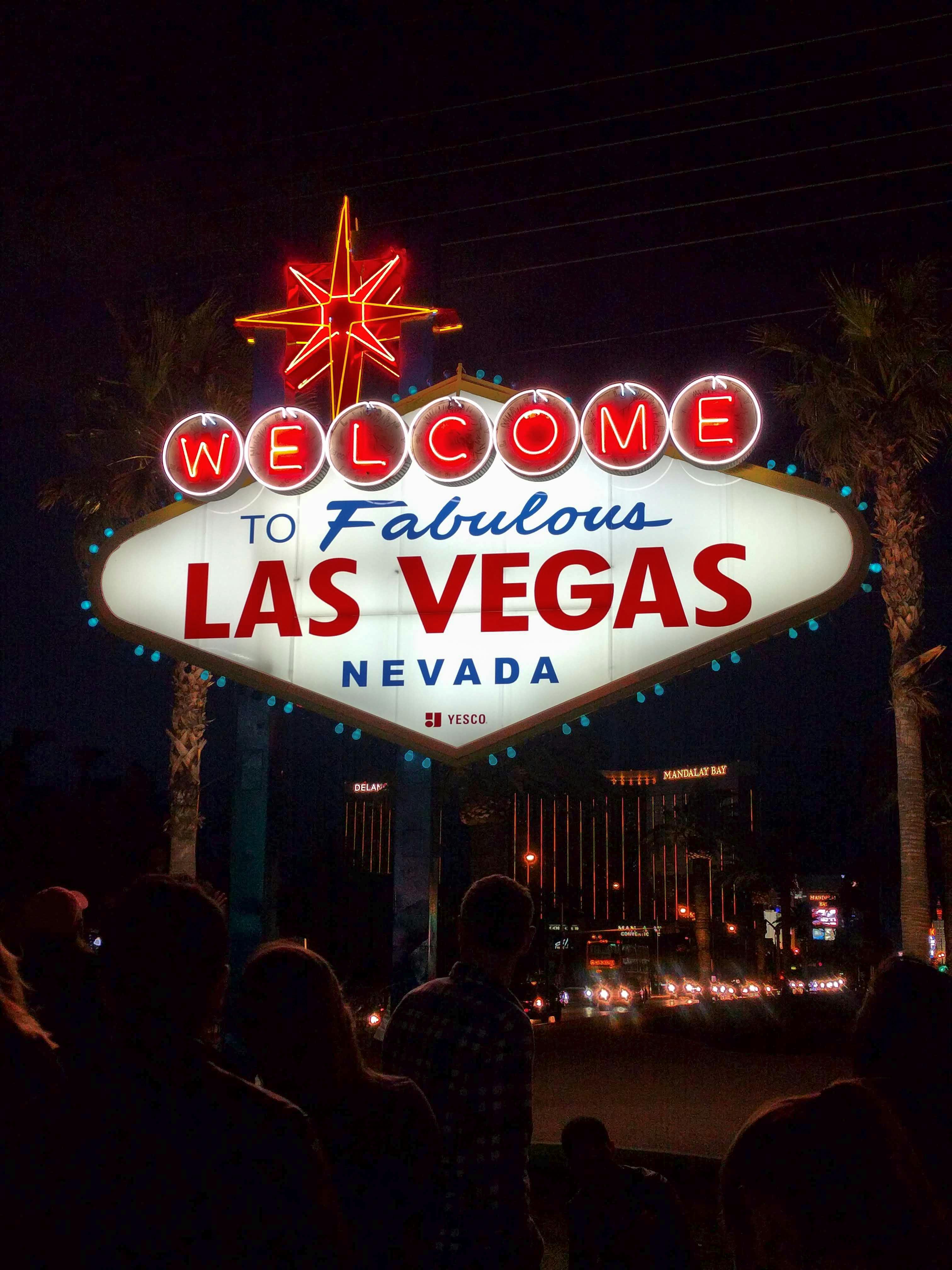 The famous Welcome to Las Vegas sign illuminated at night, attracting visitors.