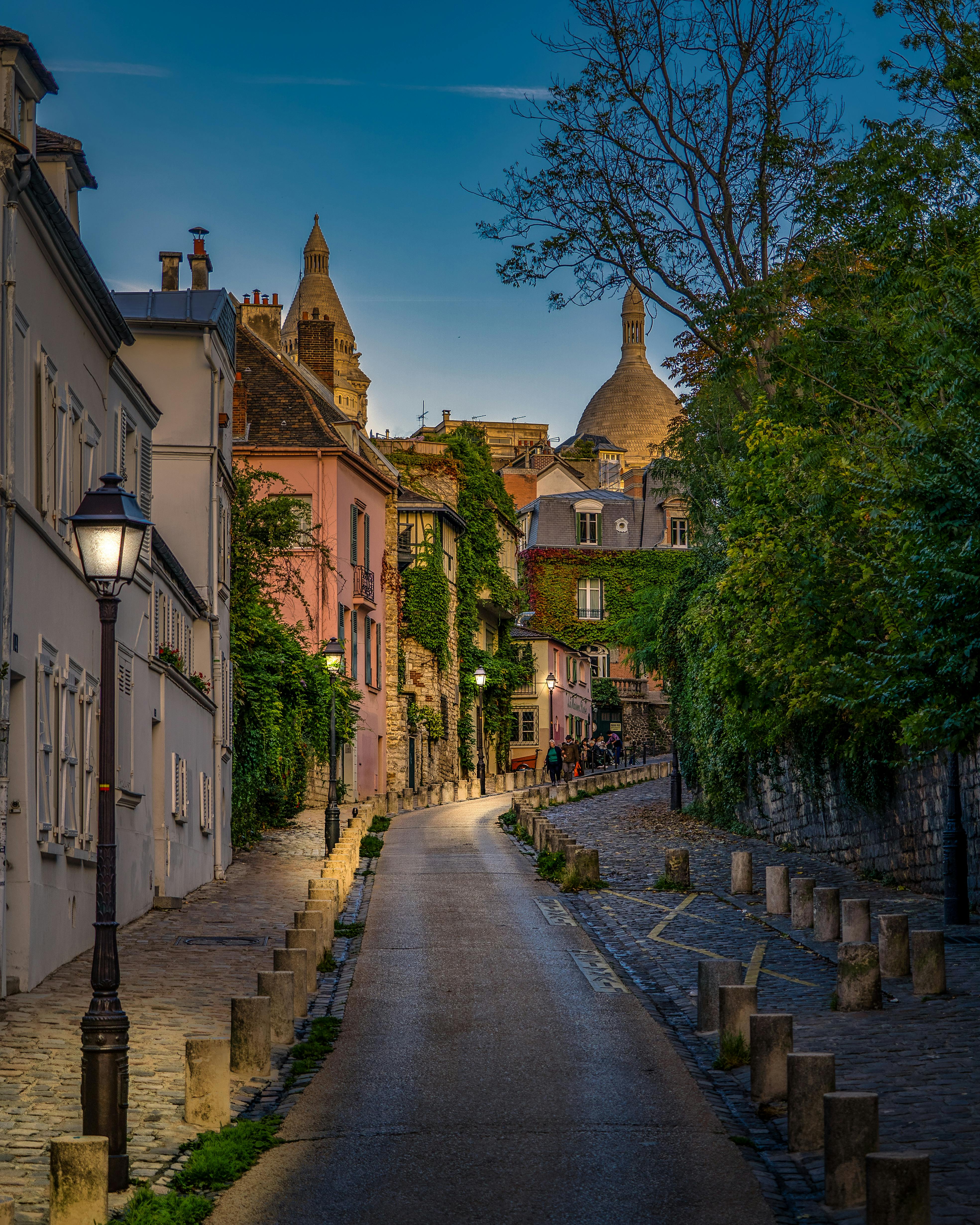 Explore a picturesque evening street in Montmartre, Paris, surrounded by historic architecture.