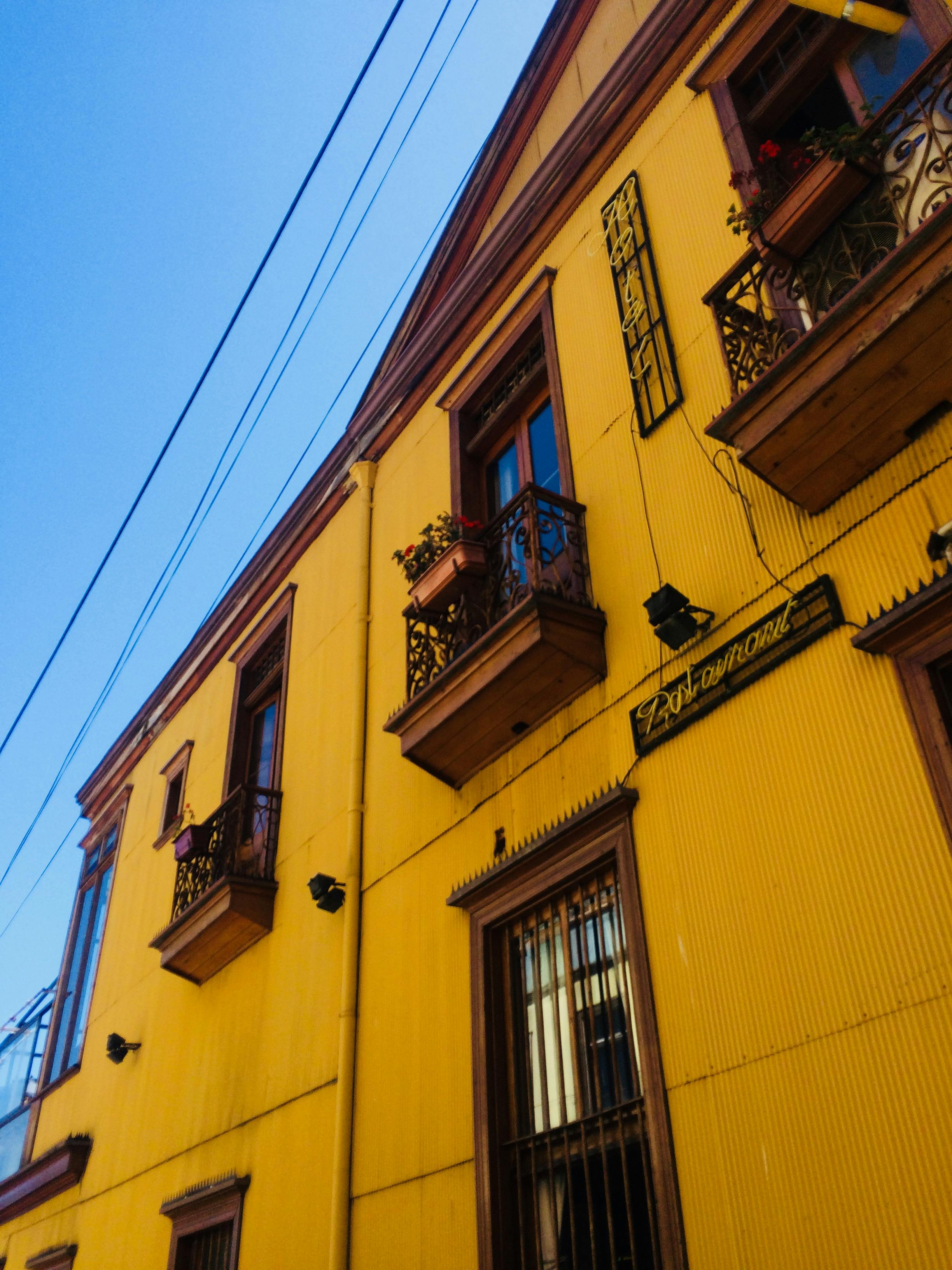 Vibrant yellow building in Valparaíso showcasing colorful architecture and unique design.