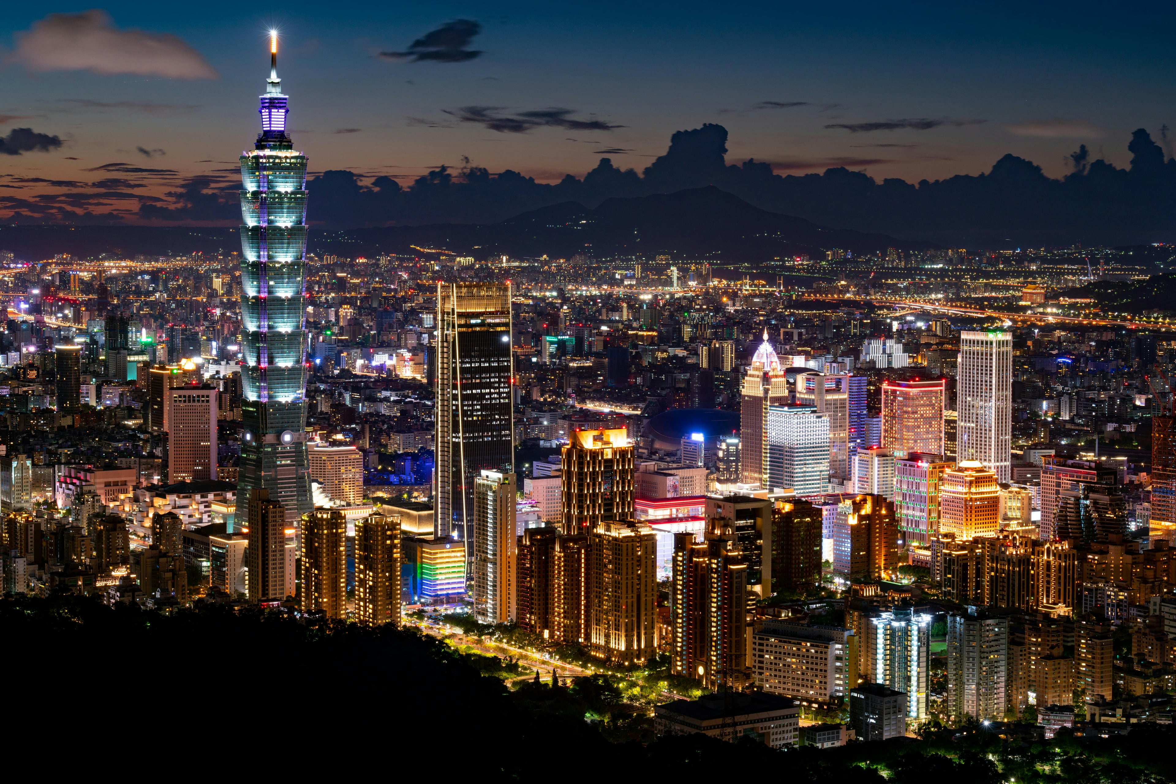 A stunning night view of Taipei showcasing the iconic Taipei 101 and shimmering city lights.