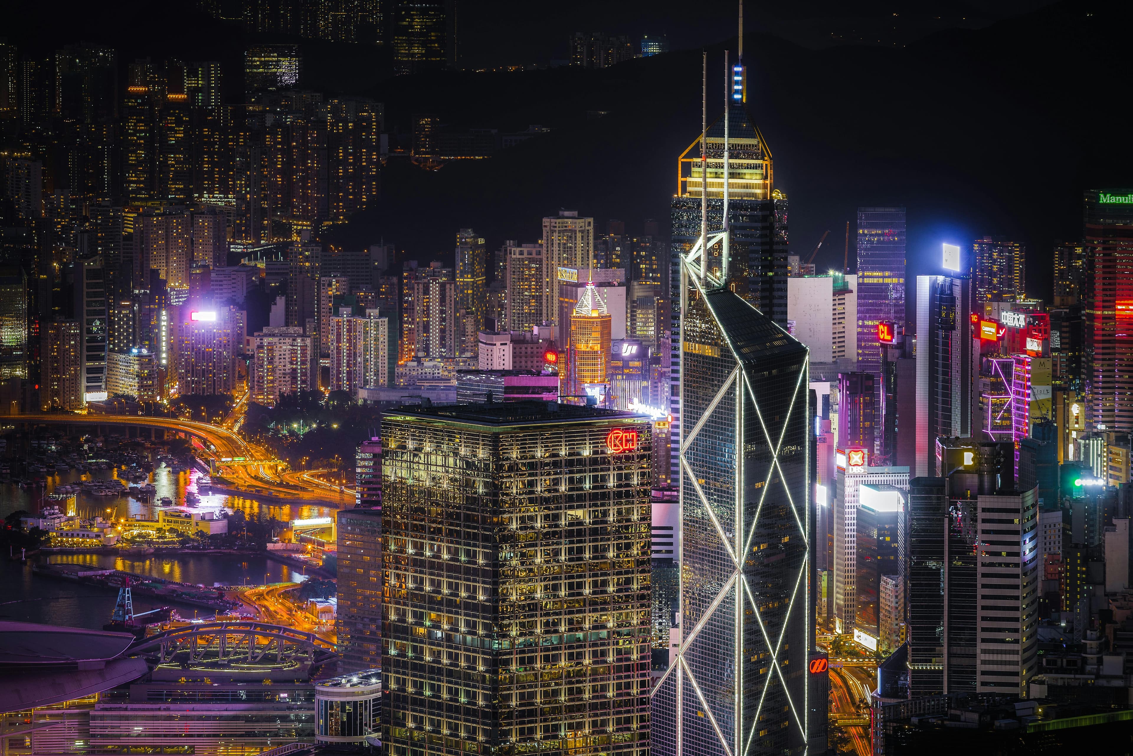 Spectacular view of Hong Kong skyscrapers illuminated at night showcasing modern architecture and urban life.