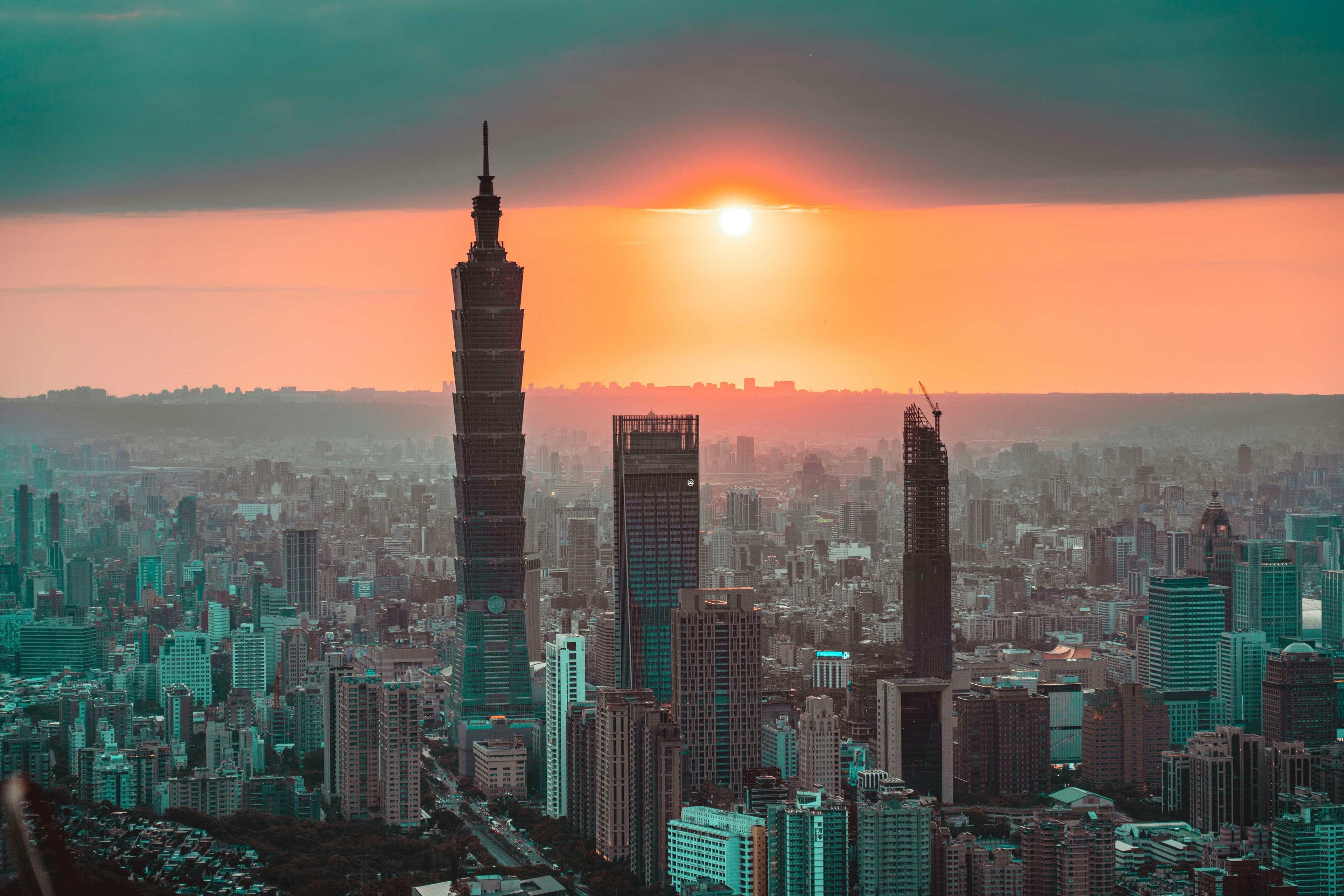 A breathtaking view of Taipei city and Taipei 101 at sunset, showcasing the vibrant urban skyline.